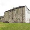 View of the north (rear) elevation of the coach house, including slit openings