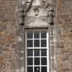 Detail of window with carved stone pediment on east gable of south facade
