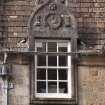 Detail of dormer window with carved stone pediment on south face of north gable of west facade