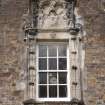 Detail of window with armorial panel above east entrance