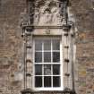 Detail of window with armorial panel above east entrance