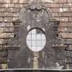 Detail of oval dormer window at 1st floor level on south face of north wing of east facade