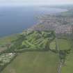 General oblique aerial view of Prestonpans centred on Royal Musselburgh Golf Course, taken from the SW.