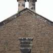 Detail of stone plaque and paired chimney stacks to gablehead of rear, north west elevation.