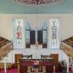 General view  looking across the upper level of the sanctuary, including central ceiling rose and organ pipes, taken from the rear gallery.