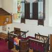 View looking down onto the raised central pulpit, taken from the side gallery above.