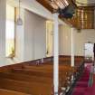 View looking along side aisle of church, showing side gallery and ground floor pews.