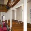 View looking along side aisle of church, showing side gallery and ground floor pews.