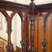 Detail of baluster newels and carved rails on raised pulpit.