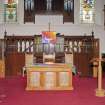 View of chancel area with pulpit and furniture.