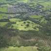 General oblique aerial view of Comrie centred on the golf course, taken from the NNE.