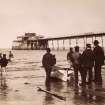 View of men and boat on beach by Portobello pier.
Titled: 'Boating. J P. 135'.
Subtitled in pencil: 'Portobello Blown down after 1918'.
PHOTOGRAPH ALBUM NO.195: PHOTOGRAPHS BY G W WILSON & CO