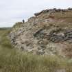 View of the eroding midden deposits and possible structures, taken from the W.