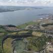 Oblique aerial view of the New Forth Bridge site, North Shore, taken from the NE.