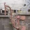 Detail of cast iron lamp bracket on east entrance pavillion.