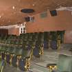 Auditorium. Balcony seating and curved wall of projection room.