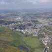 General oblique aerial view of Holyrood Park, Calton Hill, Royal Mile, Old Town and New Town, looking W.