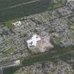 Oblique aerial view of Aviemore centred on the newly constructed Health Centre, looking NW.