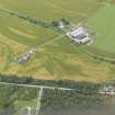 Oblique aerial view of the cropmarks of the field boundaries, possible sunken floored buildings and pits, looking SW.