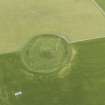 Oblique aerial view of Maeshowe Chambered Cairn, looking SSE.