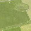 Oblique aerial view of Maeshowe Chambered Cairn, looking NE.