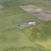 Oblique aerial view centred on the farmstead and graveyard at Holland, Stronsay, looking NE.