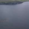 Oblique aerial view of the Pelamis wave energy converter at the European Marine Energy Centre (EMEC), with Black Craig beyond, looking E.