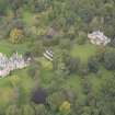 General oblique aerial view of Vogrie House with adjacent stables, looking to the WNW.