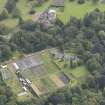 General oblique aerial view of Oxenfoord Castle with adjacent walled garden, looking to the SE.