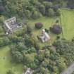 General oblique aerial view of Cranston Parish Church with adjacent churchyard and Oxenfoord Castle stables, looking to the SE.