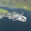 Oblique aerial view of Scalloway Harbour, looking E.