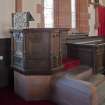 Interior. View of font and choir stalls