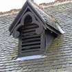 Detail of gabled, barge-boarded dormer vent to roof of station building.