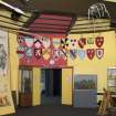 Interior. View to entrance doors of the education room, including heraldic shields and interpretive displays.