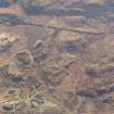 Oblique aerial view of the buildings and field boundaries, looking SSE.