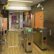 Interior. View looking back into concourse of Kelvinhall subway station, showing turnstiles, ticket office and entrance