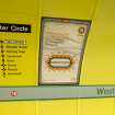  Detail view of signage and network maps on the tunnel wall of West Street subway station