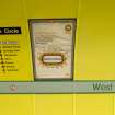 Detail view of signage and network maps on the tunnel wall of West Street subway station