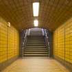 View looking along tiled corridor to main stair up to concourse level of West Street subway station