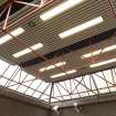 View looking up at the exposed structure and rooflights of the concourse at West Street subway station