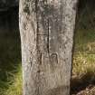 View of cross-incised gravemarker (1) located in graveyard to north of church (flash)