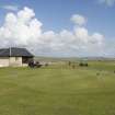 Starter's hut and practice green from west.