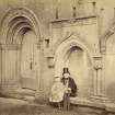 View of processional doorway and seat with man and child, Melrose Abbey.