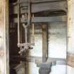 Interior. View looking into machinery cupboard to main drive shaft and mill workings.