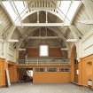 Interior. General view looking along the 1st floor sports hall to the viewing gallery.