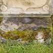 Straight on view of font or possible bullaun stone built into east wall of burial ground