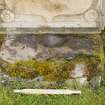 Straight on view of font or possible bullaun stone (with scale) built into east wall of burial ground