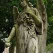 Detail of a monumental statue of an angel holding roses, in the Grange Cemetery, Edinburgh.