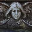 Detail of relief showing the head and wings of an angel, New Dean Cemetery, Edinburgh.