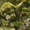 Detail of a relief showing the head and wings of an angel, covered in moss. Saint Cuthbert's Cemetery, Edinburgh.